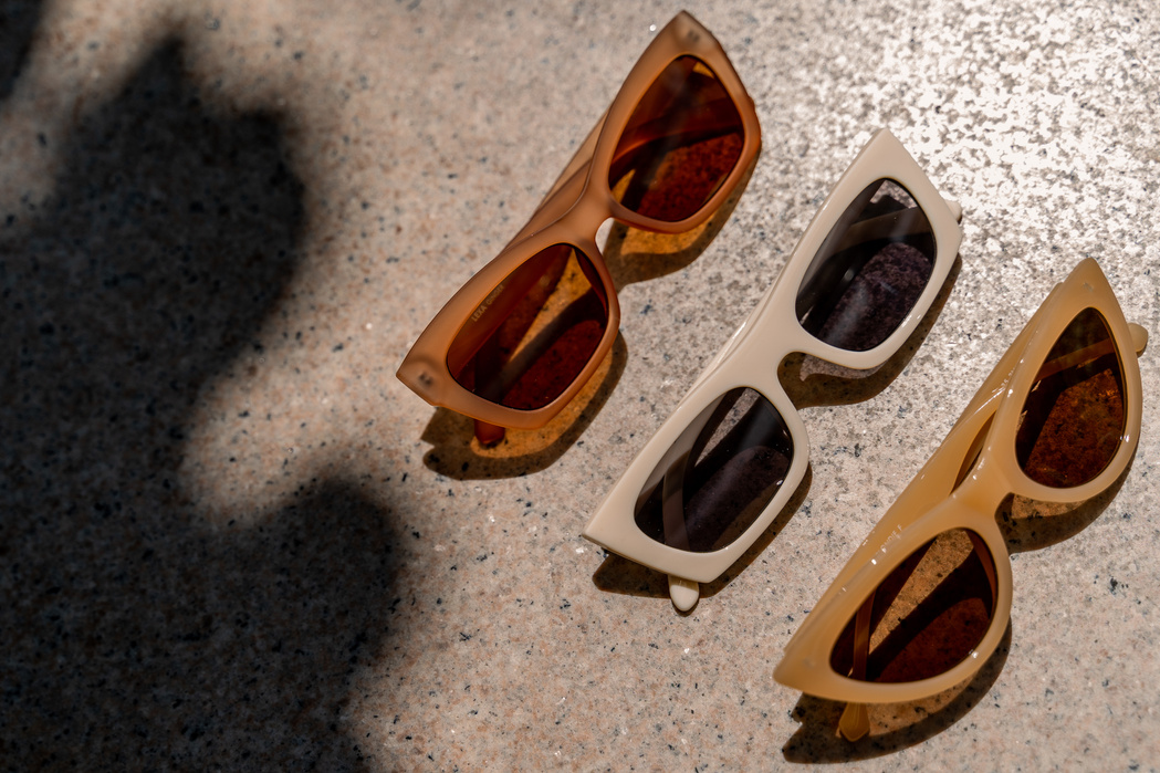 Brown Sunglasses on Concrete Floor